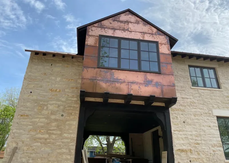 Copper metal panel facade on a stone building for Skylight Installation in Coon Rapids